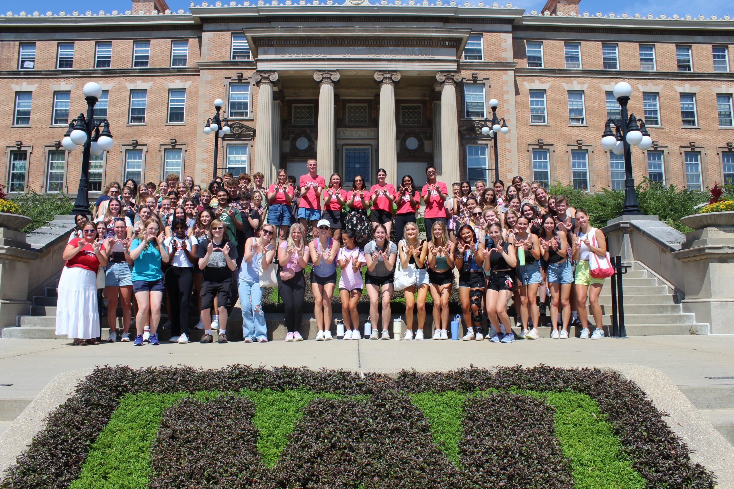 A large group of students pose for a picture outside of Agricultural Hall