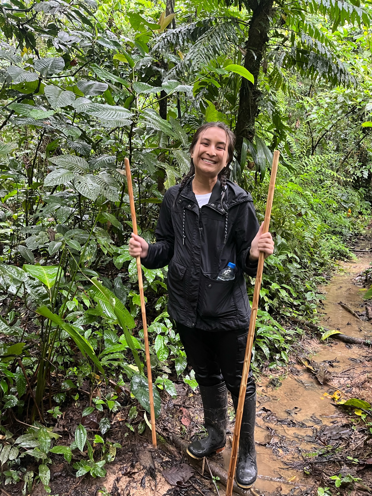 A student stands in a forest in Ecuador